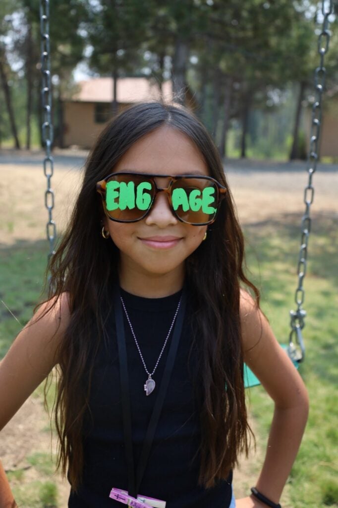 Junior high girl in painted Engage sunglasses